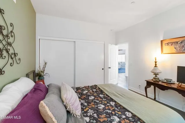 a bedroom with a bed and a lamp