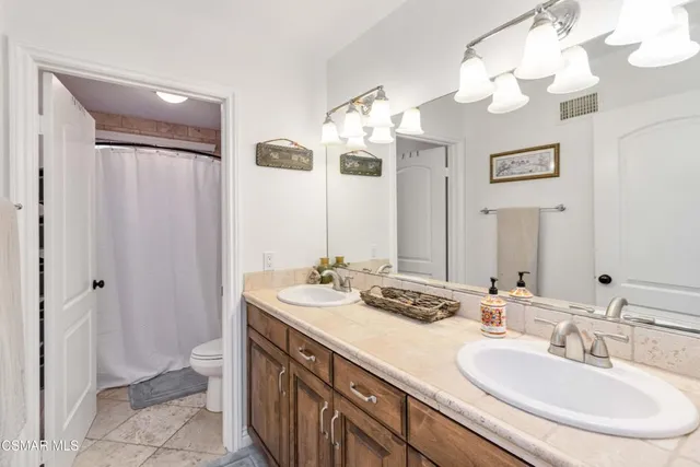 a bathroom with a double vanity sink and a mirror