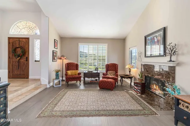 a living room with furniture and a fireplace