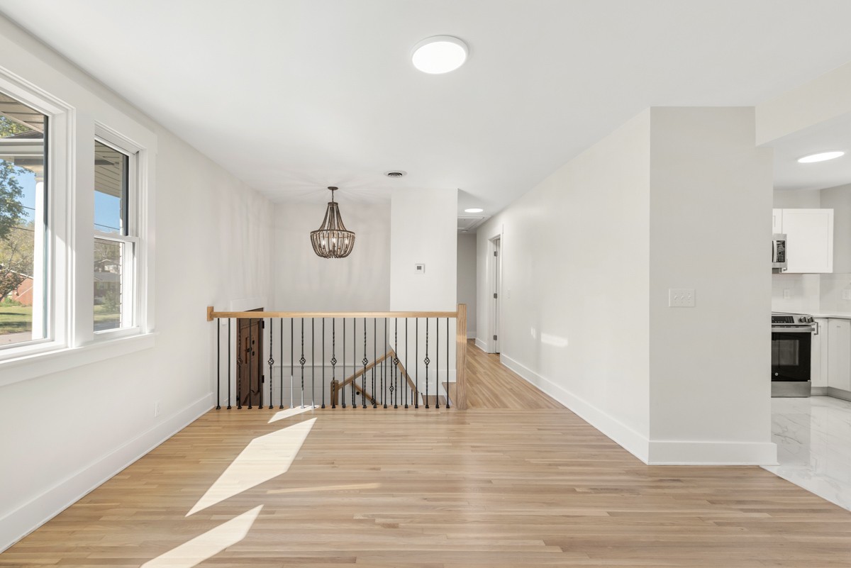 612 May Drive Madison, TN 37115 - Photo 11 of 46 a view of a hallway with wooden floor and a living room