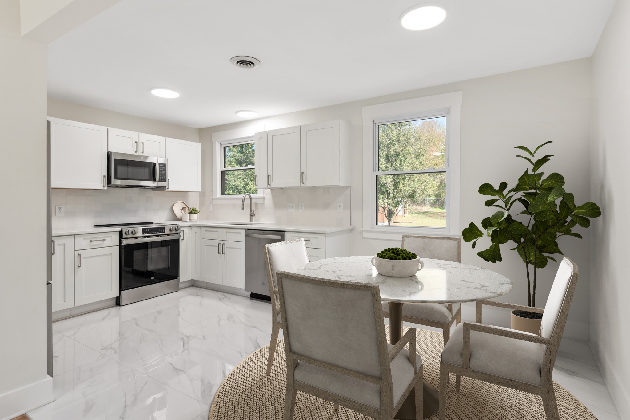 612 May Drive Madison, TN 37115 - Photo 12 of 46 a kitchen with a stove a sink a microwave a dining table and chairs