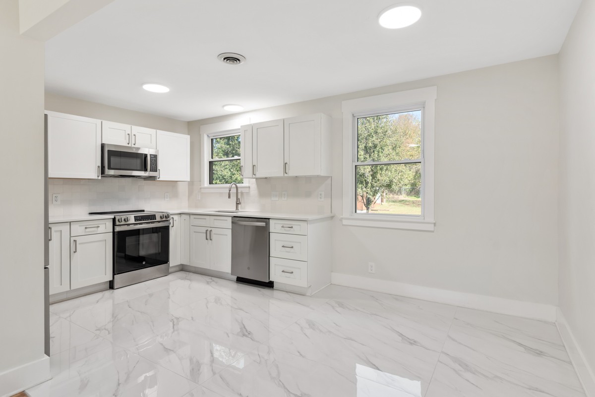 612 May Drive Madison, TN 37115 - Photo 13 of 46 a kitchen with a stove a sink and a microwave