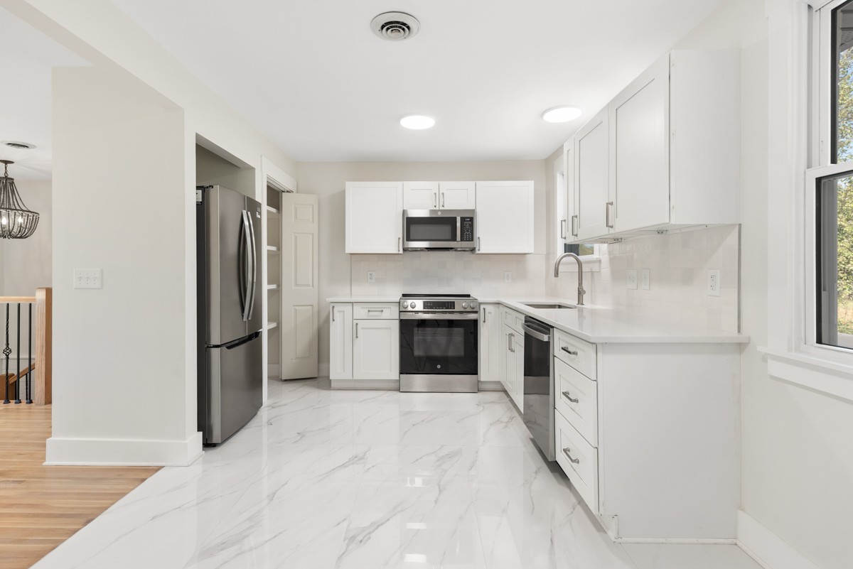 612 May Drive Madison, TN 37115 - Photo 14 of 46 a kitchen with stainless steel appliances a refrigerator sink and white stove