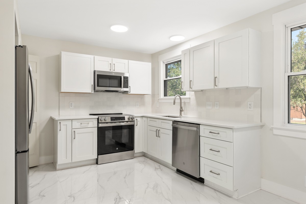 612 May Drive Madison, TN 37115 - Photo 15 of 46 a kitchen with white cabinets and a stove top oven