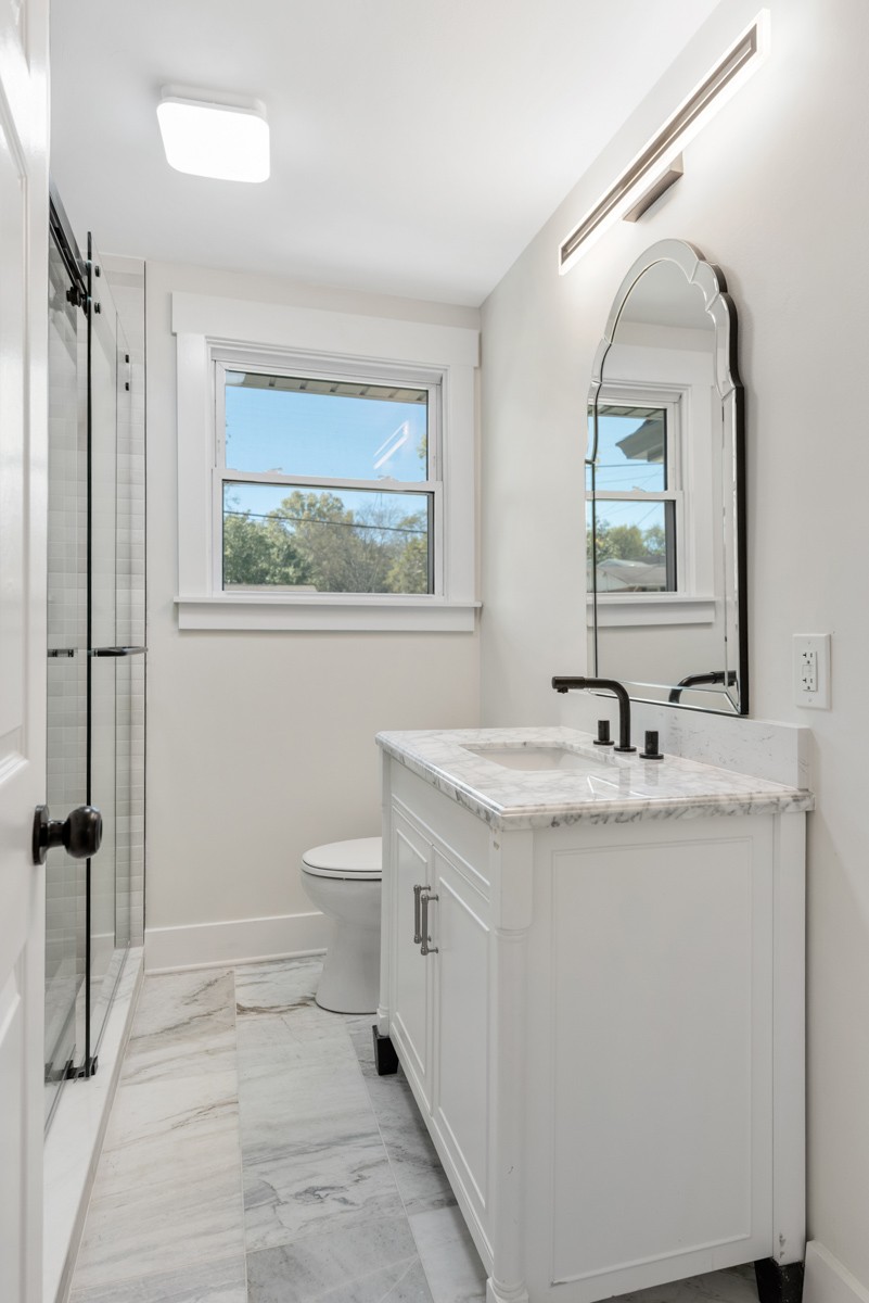 612 May Drive Madison, TN 37115 - Photo 21 of 46 a bathroom with a granite countertop sink a toilet and a mirror
