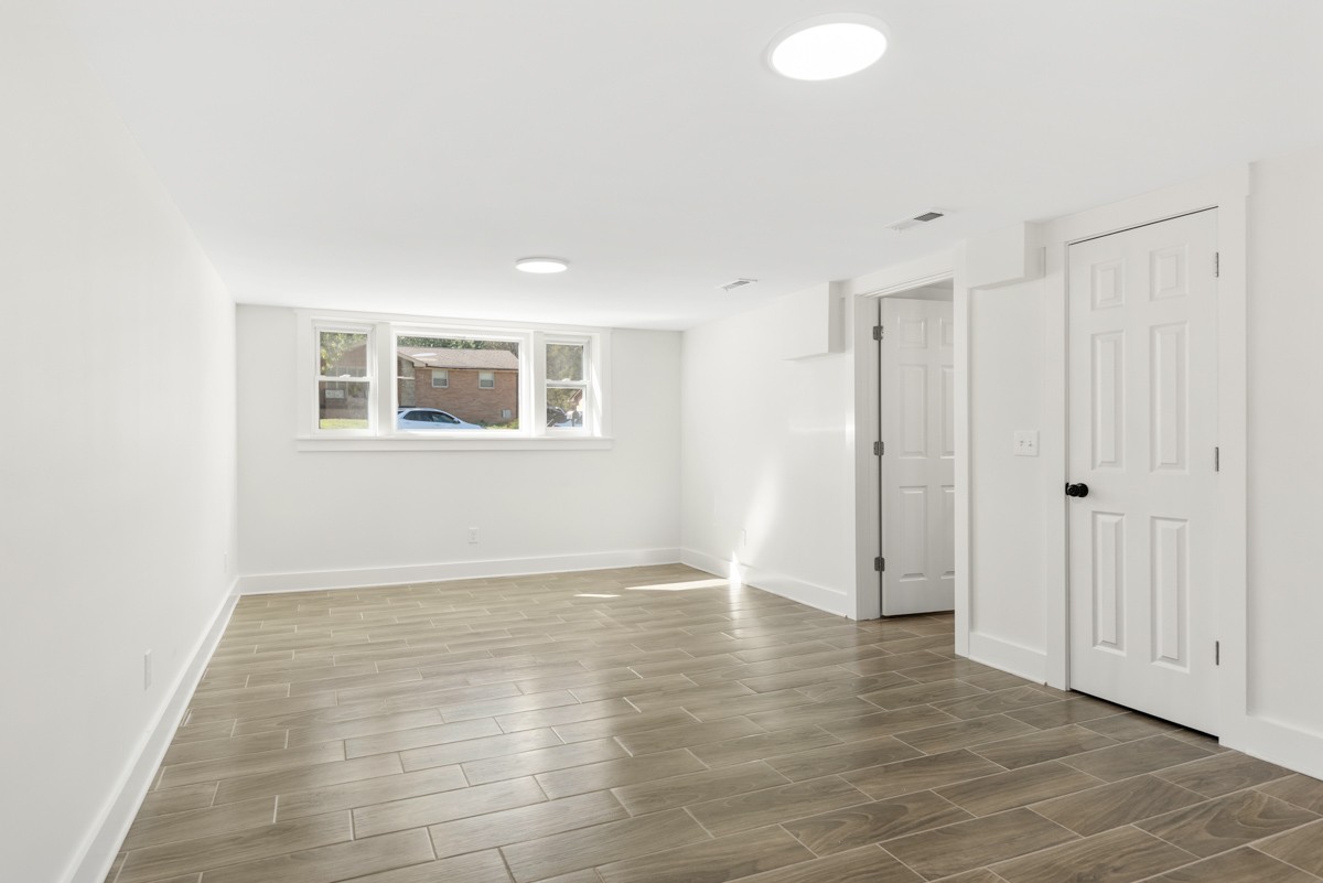 612 May Drive Madison, TN 37115 - Photo 30 of 46 a view of an empty room with wooden floor and a window