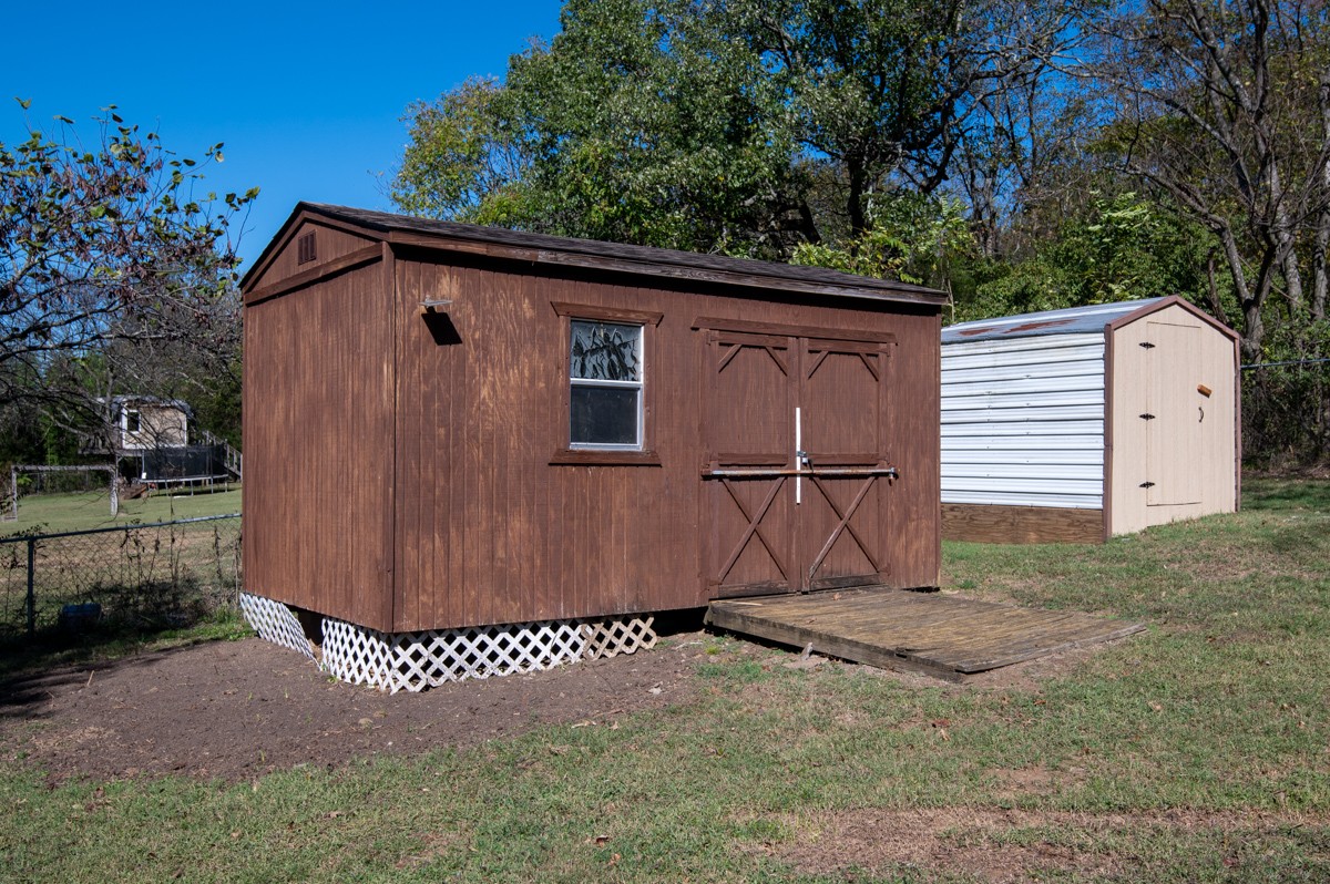 612 May Drive Madison, TN 37115 - Photo 44 of 46 a view of a barn house with a yard plants and wooden fence