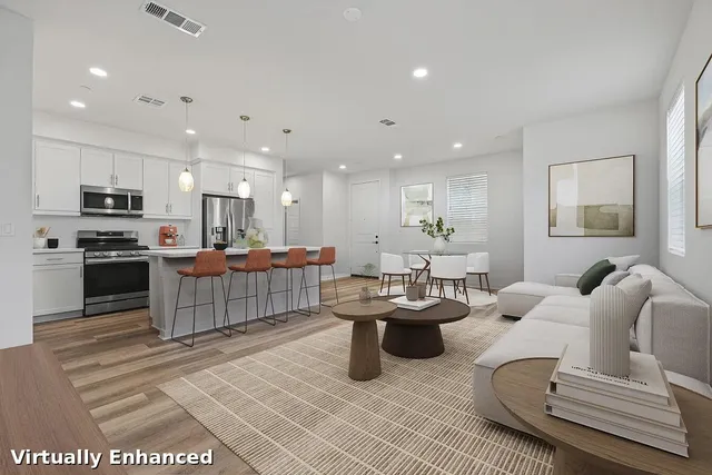 a living room with furniture and kitchen view