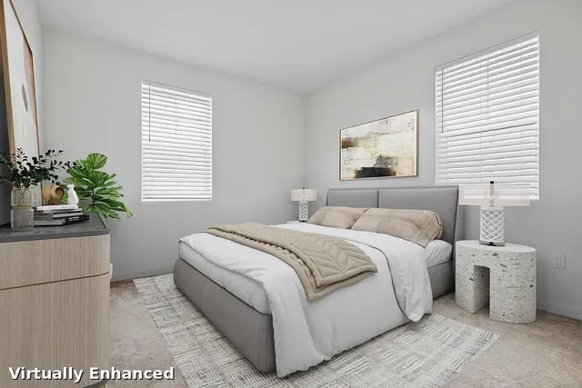 a bedroom with a bed and a potted plant