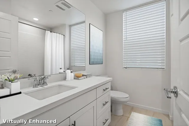 a bathroom with a sink a toilet and mirror