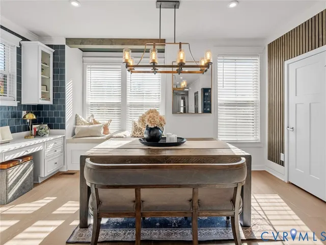 a dining room with a table chairs and entryway