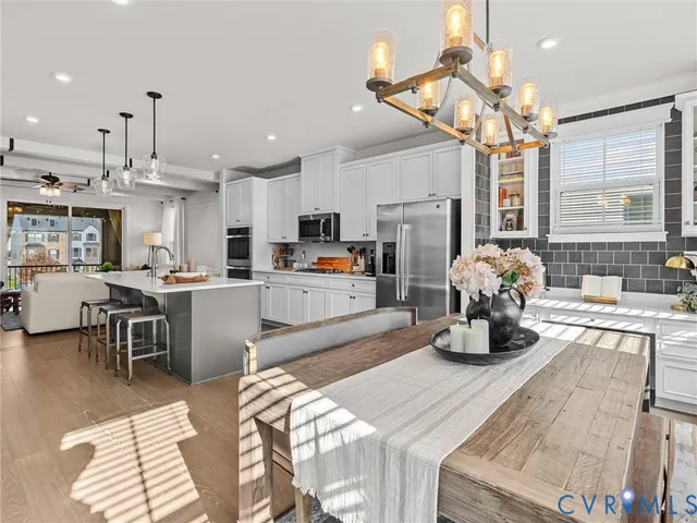a kitchen with a sink appliances and dining table