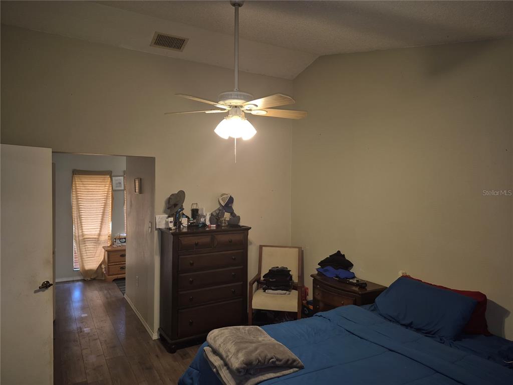 13710 Whitby Road Hudson, FL 34667 - Photo 7 of 21 a bedroom with a bed and wooden floor