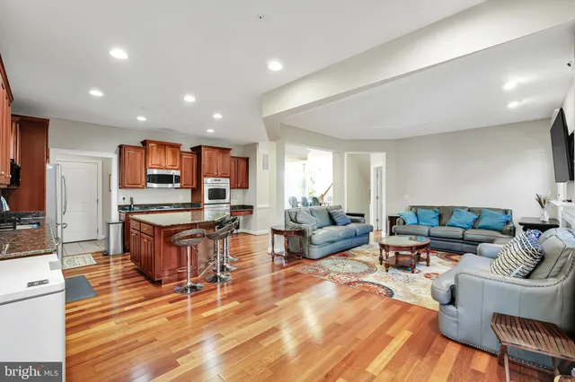 a living room with fireplace furniture and a wooden floor