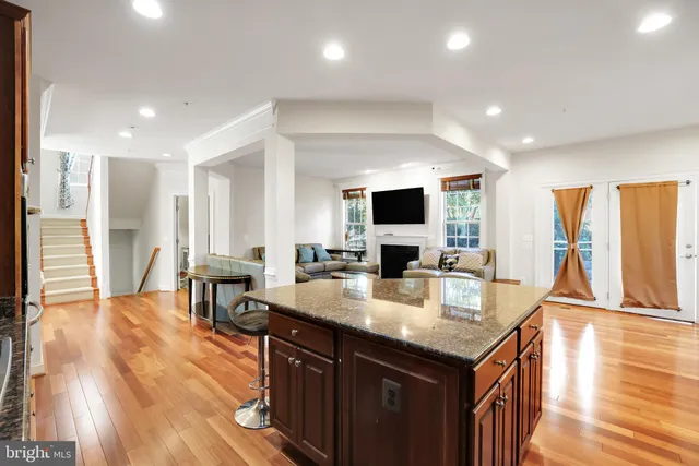 a open kitchen with stainless steel appliances granite countertop a sink and dishwasher with wooden floor