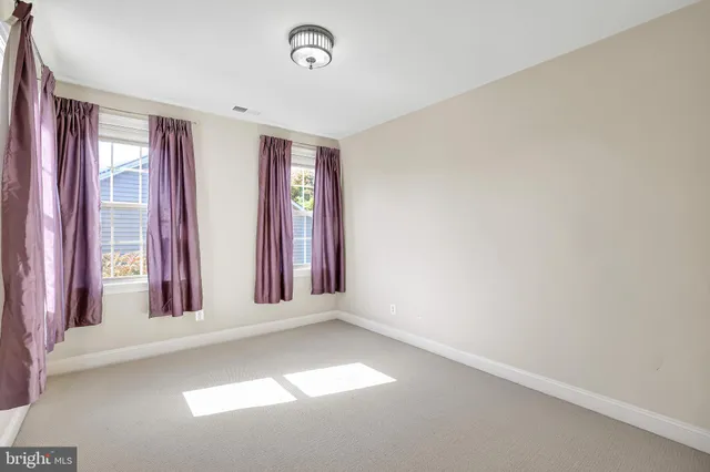 a view of a room with a window and a kitchen