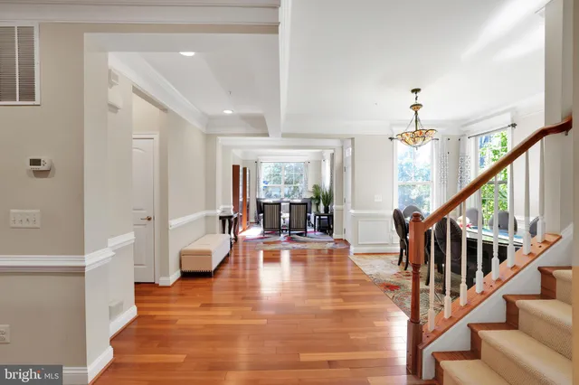 a view of an entryway with wooden floor and a livingroom view