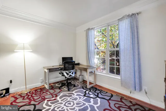 a hallway with furniture and a flat screen tv