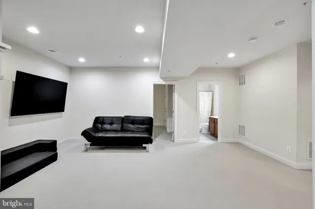 a kitchen with stainless steel appliances kitchen island granite countertop a refrigerator a stove a sink dishwasher and a dining table with wooden cabinet