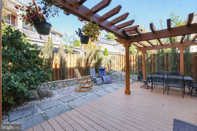 a patio with glass top table and chairs