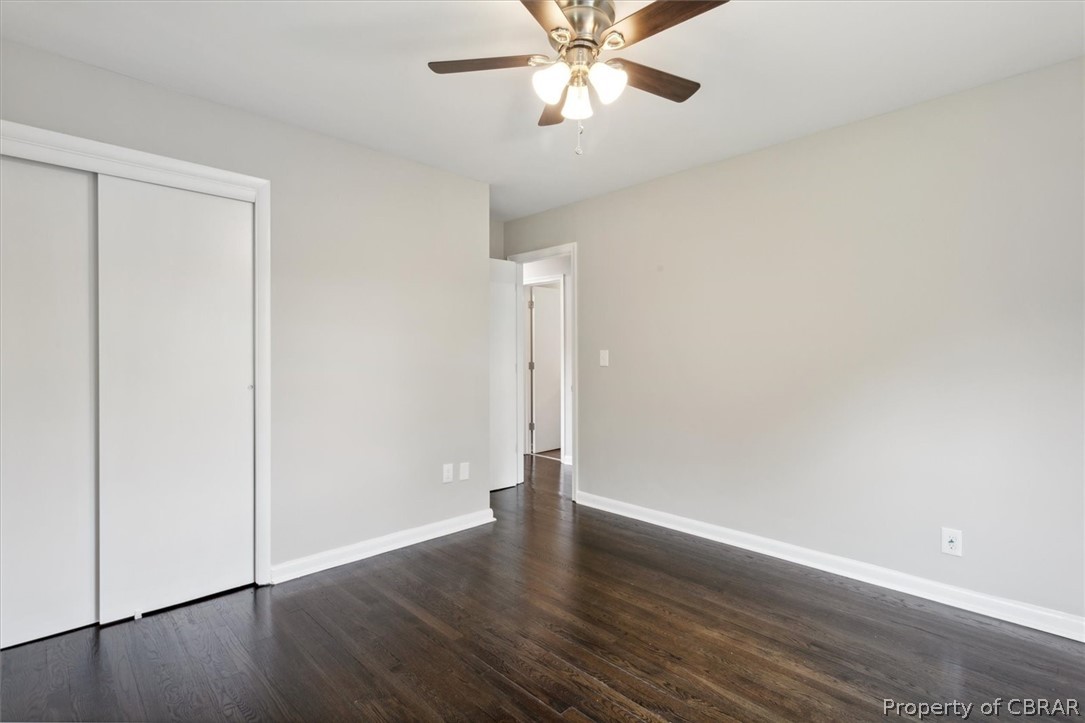 9040 Diascund Road Lanexa, VA 23089 - Photo 30 of 37 Unfurnished bedroom featuring ceiling fan, dark hardwood / wood-style flooring, and a closet