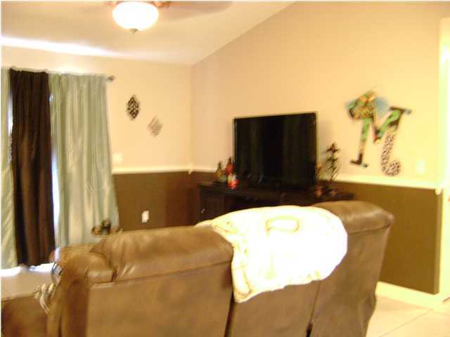 24270 Mcphail Farm Road Florala, AL 36442 - Photo 13 of 25 a living room with a bed furniture and a flat screen tv