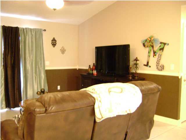24270 Mcphail Farm Road Florala, AL 36442 - Photo 14 of 25 a living room with a couch and a flat screen tv