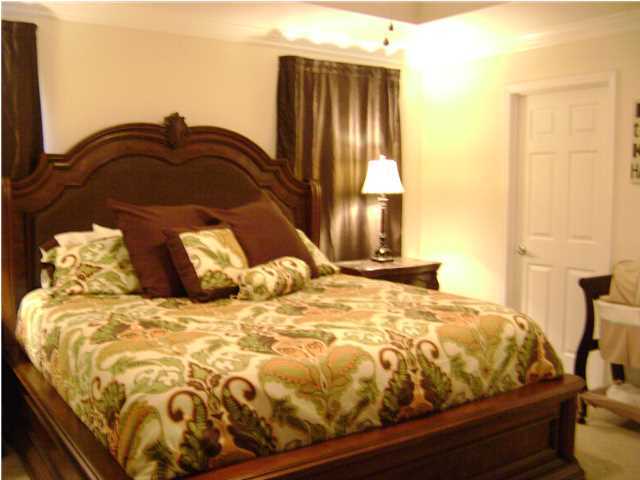24270 Mcphail Farm Road Florala, AL 36442 - Photo 9 of 25 a bed sitting in a bedroom next to a window