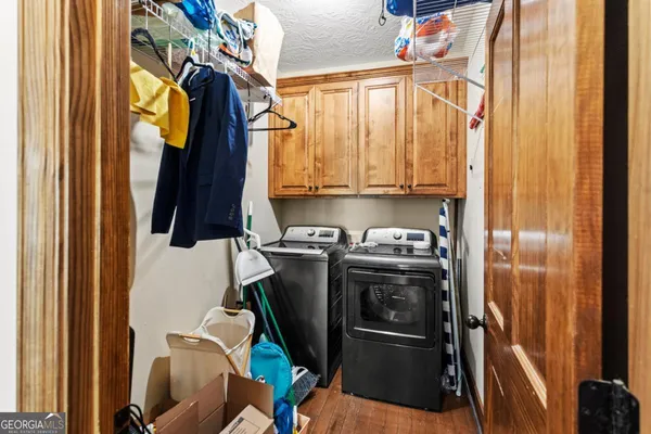 a view of walk in closet with clothes