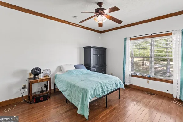 a bedroom with a big bed and a chandelier