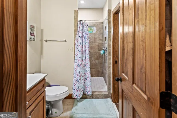a bathroom with a toilet a sink and a shower