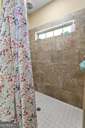 a bathroom with a shower and a sink