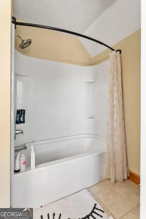 a bathroom with a bathtub and a shower