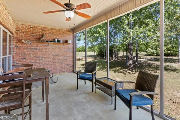 a view of a house with swimming pool and furniture