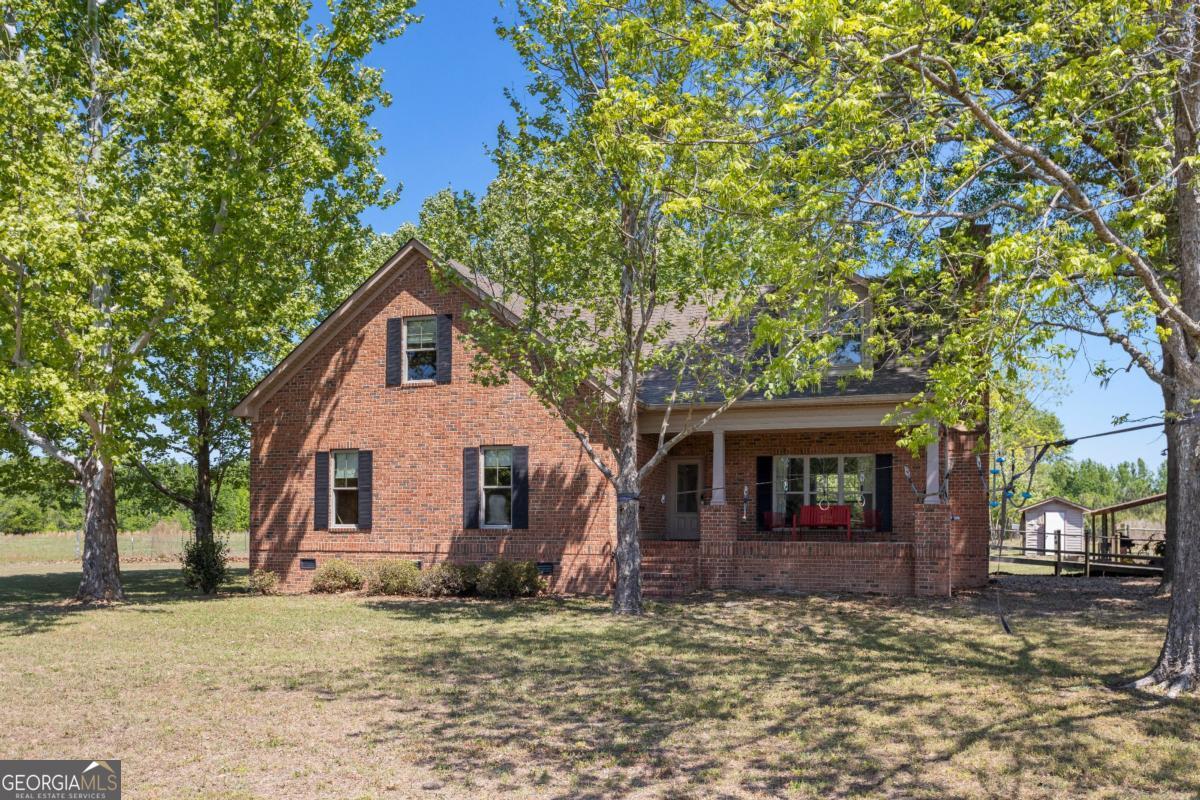 1747 Perkins Green Fork Road Millen, GA 30442 - Photo 32 of 39 a front view of a house with garden