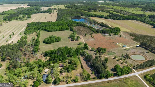 an aerial view of a house with a yard