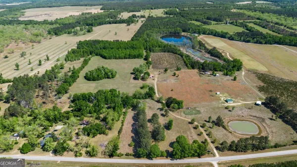 an aerial view of a house with a yard and lake view
