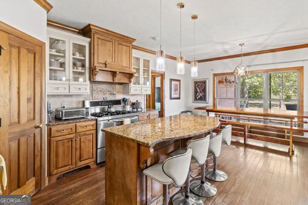 a kitchen with stainless steel appliances granite countertop a stove and cabinets