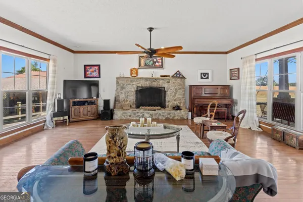 a living room with furniture a fireplace and a flat screen tv
