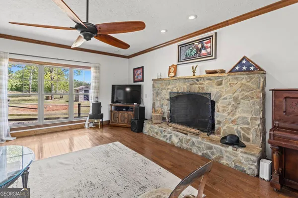 a living room with furniture a flat screen tv and a fireplace