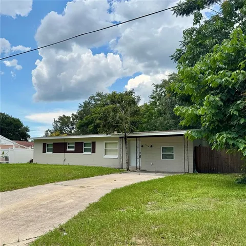 a front view of house with yard and green space
