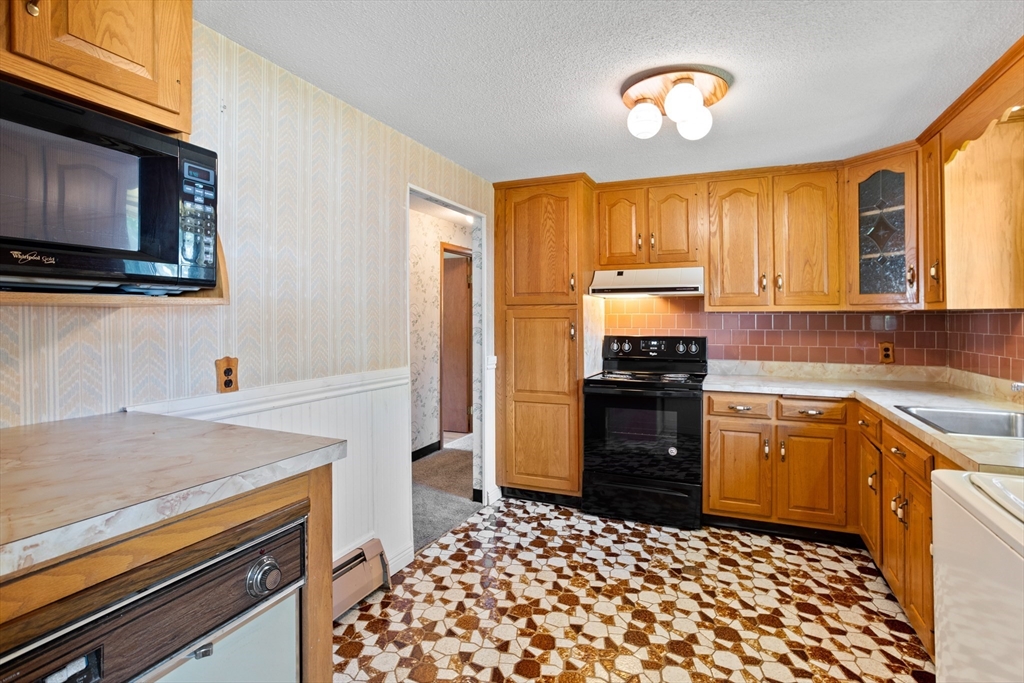 52 Brooks Street Maynard, MA 01754 - Photo 12 of 28 a kitchen with a stove and a microwave