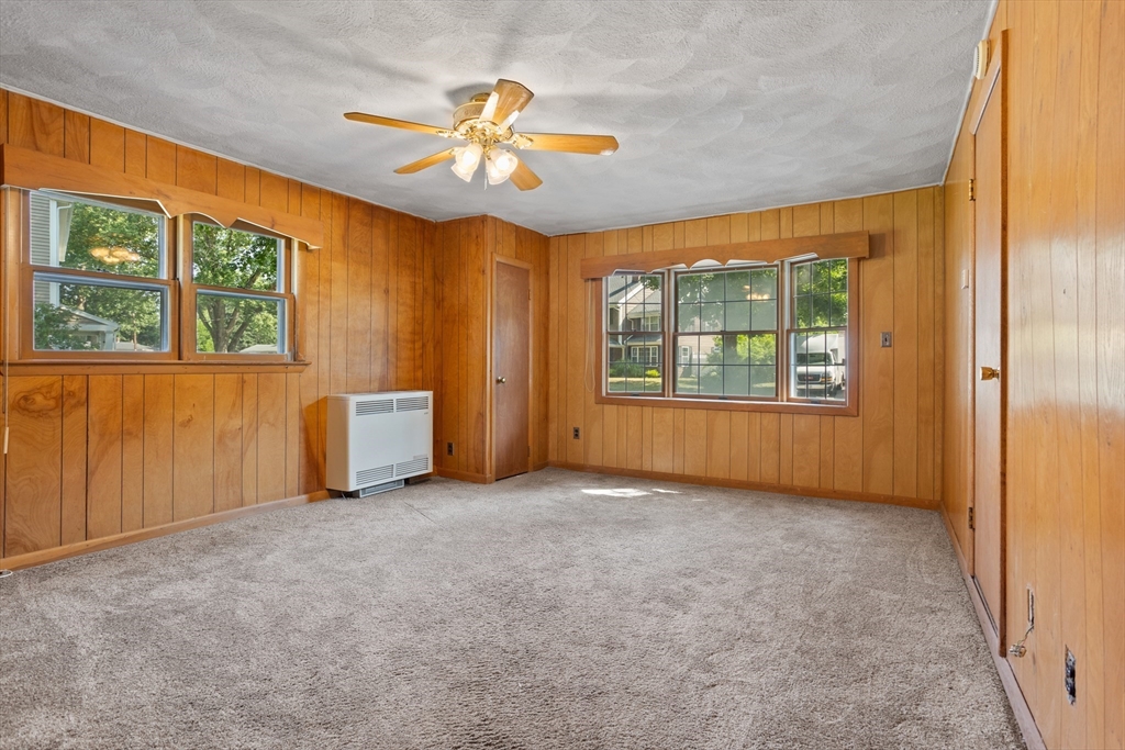 52 Brooks Street Maynard, MA 01754 - Photo 13 of 28 an empty room with windows and chandelier fan