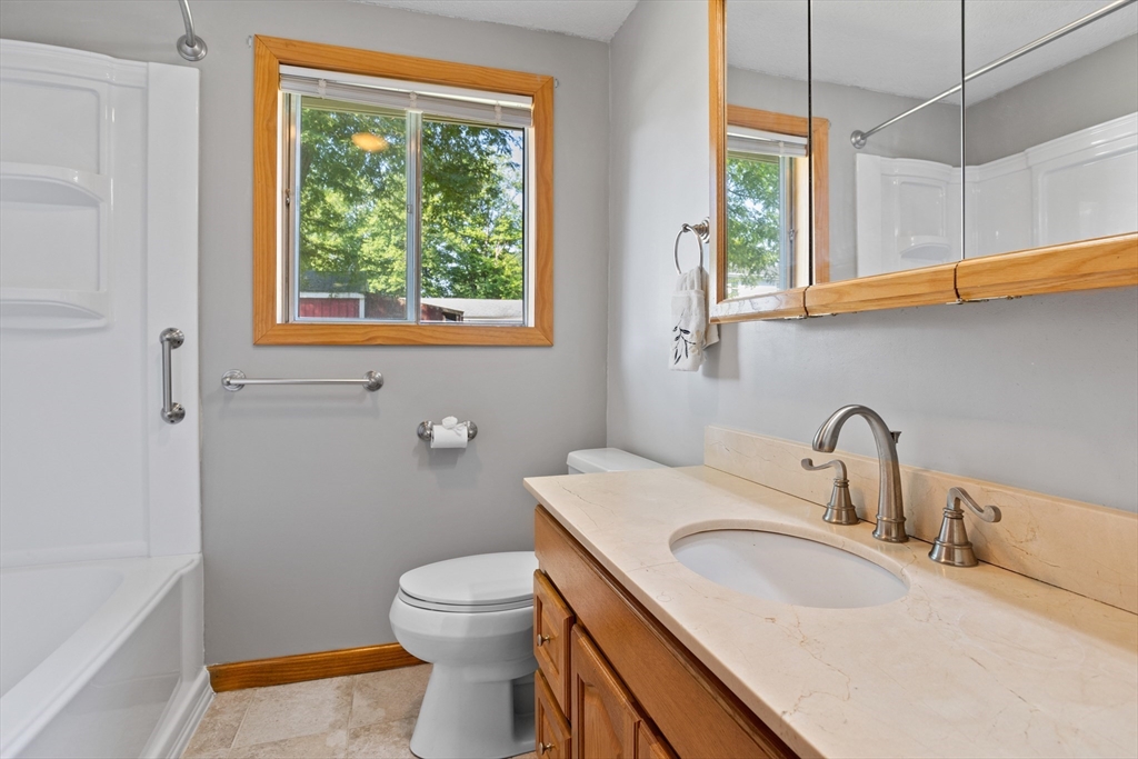 52 Brooks Street Maynard, MA 01754 - Photo 15 of 28 a bathroom with a sink a toilet and a window