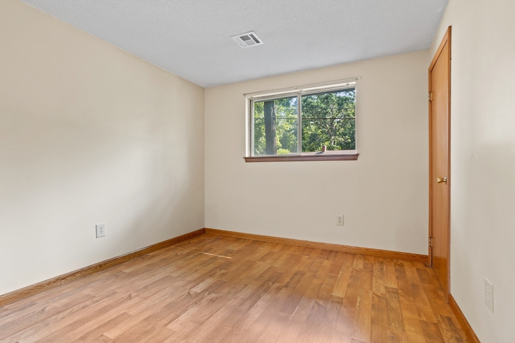 52 Brooks Street Maynard, MA 01754 - Photo 16 of 28 a view of an empty room with wooden floor and a window