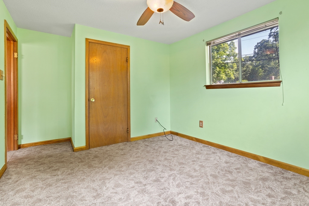 52 Brooks Street Maynard, MA 01754 - Photo 19 of 28 an empty room with window and a ceiling fan