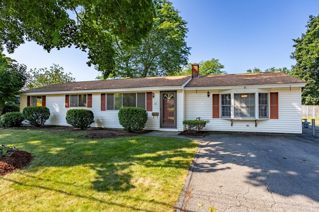 52 Brooks Street Maynard, MA 01754 - Photo 2 of 28 a front view of a house with a garden