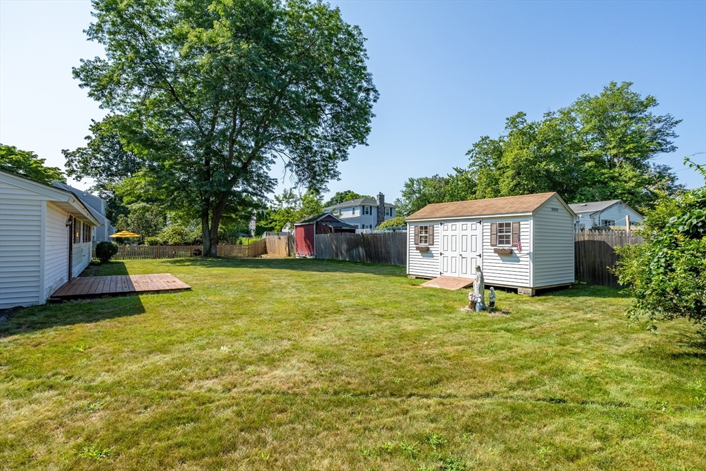 52 Brooks Street Maynard, MA 01754 - Photo 24 of 28 a view of a house with backyard and a tree