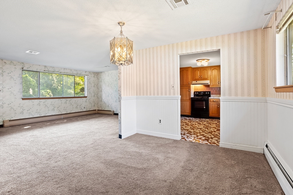 52 Brooks Street Maynard, MA 01754 - Photo 9 of 28 wooden floor in an empty room with a window