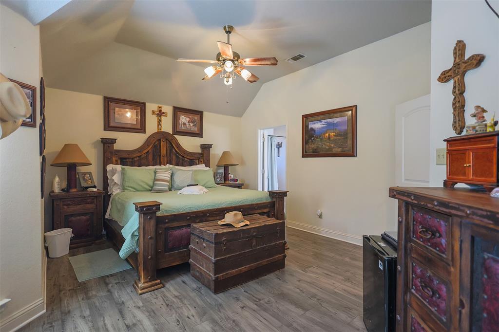 111 Deerfield Road Paradise, TX 76073 - Photo 15 of 39 Bedroom with dark wood-style floors, ceiling fan, lofted ceiling, and black refrigerator